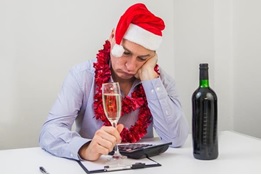 Image of guy depressed, with a glass of wine